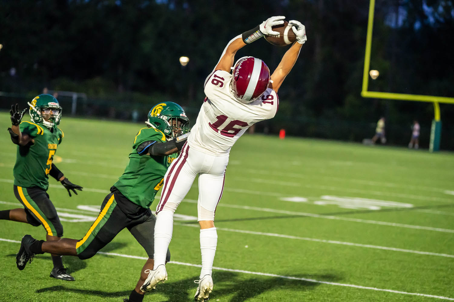 WR going up for the catch WR going up for the catch